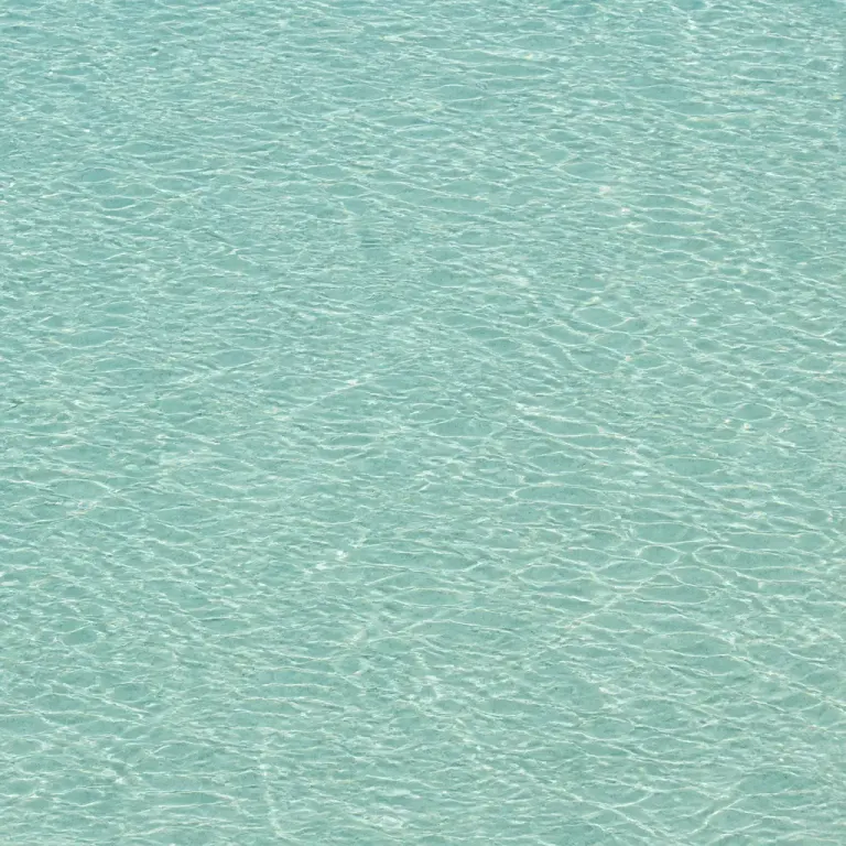 Even overhead texture of pale rippled water with sparse fine mineral particles and seamless edges