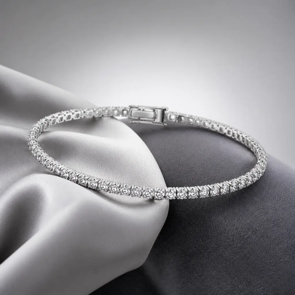 Backlit tennis bracelet with clear gemstones arranged over silver silk on a gray gradient background